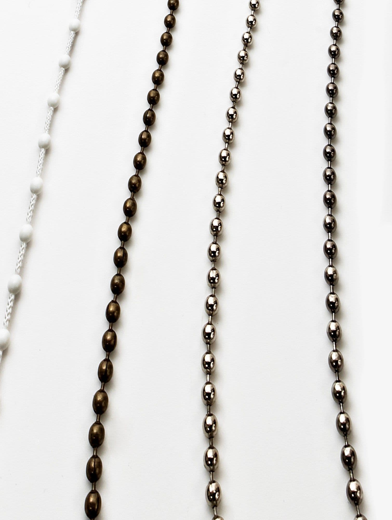 Four vertical blind pull chains â€” a left white braided cord with spaced beads, a bronze beaded chain and two steel ball chains â€” hanging straight against a white background, evenly lit.