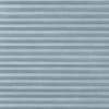 Light-blue pleated cellular shade, horizontally folded and textured, fully lowered and closed, softly filtering daylight across a neutral interior window with no visible view.