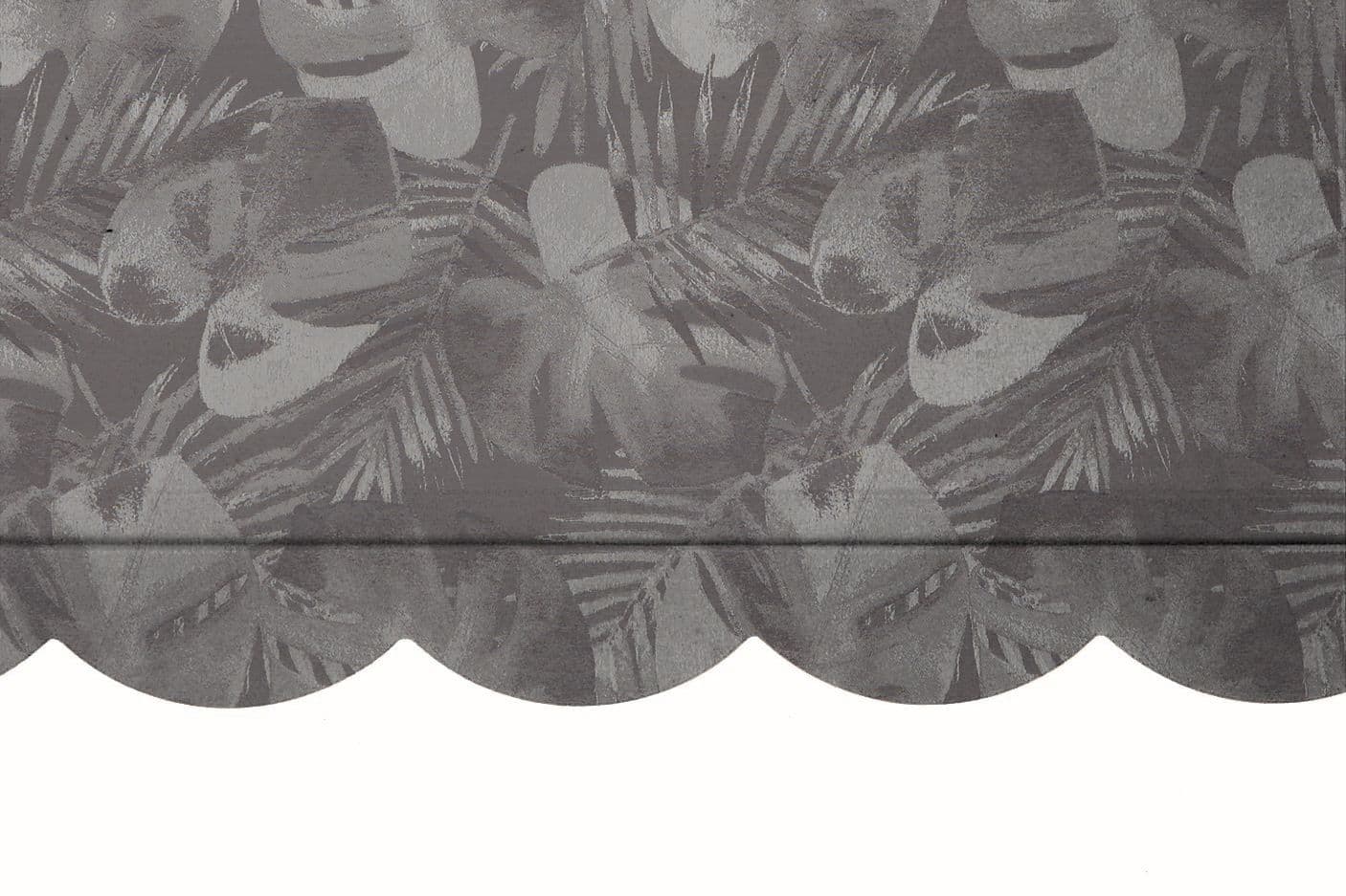 Scalloped fabric valance with gray tropical-leaf pattern hangs across the top of an opening, draping with a horizontal fold seam; close-up interior view with neutral, even lighting.