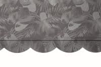 Scalloped fabric valance with gray tropical-leaf pattern hangs across the top of an opening, draping with a horizontal fold seam; close-up interior view with neutral, even lighting.