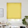 Yellow pleated blind, fully lowered across a window; blocking and softly diffusing daylight in a bright minimalist dining area with round table, vase of flowers, framed art and fiddle‑leaf fig.