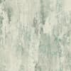Distressed abstract wall pattern displays vertical streaks and irregular splotches across a subtle teal, gray, and beige field, resembling weathered plaster or washed paint on a wall.