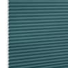Teal honeycomb (cellular) blind, fully lowered with visible white hexagonal cell edges, closed over a window; minimalist product-style setting with even, neutral lighting.