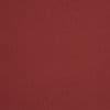 Red linen-textured fabric (main surface) covers the entire frame, showing a subtle woven pattern; evenly lit, flat, featureless backdrop suggesting a textile or wallpaper sample.