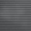 Horizontal fabric pleated blind, fully lowered and closed, featuring narrow gray ridged folds; blocking light and creating uniform texture across a neutral, softly lit interior window.