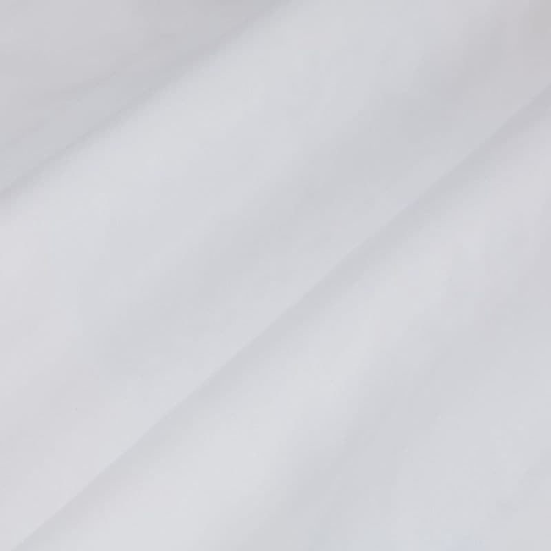 White fabric with a prominent diagonal fold, draped smoothly across the frame showing soft creases; close-up view under diffuse, neutral lighting with no visible surroundings.