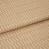 Woven upholstery fabric with a raised golden rectangular grid, folded over itself; pattern repeats diagonally across the surface, shown in a close-up, studio-lit view on a neutral background.