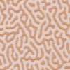 Tan squiggles snake across a pale pink, textured fabric surface, forming an irregular, maze-like dotted pattern that repeats uniformly across the full frame.