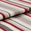 Striped woven fabric folded over itself, featuring red, gray, beige and white horizontal bands; textured knit surface; close-up product-style shot with soft, even lighting and shallow depth of field.