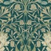 Intricate symmetrical floral pattern: cream and pale-green stylized bell and peony-like flowers entwined with curling vines and leaves across a deep teal textured background, evoking vintage wallpaper.