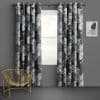 Floral grommet-top curtains with white-gray rose pattern, parted to both sides framing a window and filtering daylight in a gray-walled room with a gold chair and abstract art.