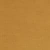 Tan, slightly mottled paper filling the frame; flat and unwrinkled, evenly lit, resembling kraft cardboard with subtle fiber texture, occupying a plain neutral background.