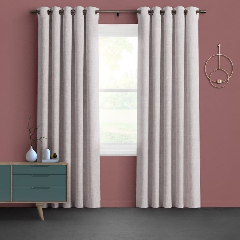 Cream grommet curtains, evenly pleated and hung on metal rod, part at center to reveal diffused daylight through double-hung window; room with rose-painted wall, teal console and gray carpet.
