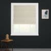 Beige patterned Roman shade lowered, filtering soft daylight through white-framed window set in a dark charcoal wall, with a small wooden side table and a framed abstract print nearby.