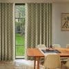 Floor-length, green-and-cream checkered curtains flanking a tall divided window, partially drawn and filtering daylight; dining table and chairs in foreground, hardwood herringbone floor, garden with grass and trees visible.