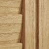 Light oak louvered shutter panel, close-up showing a slat and frame with visible grain; slats fitted and closed within the frame, warm interior lighting.