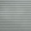 Gray horizontal pleated fabric blinds with subtle herringbone texture; fully closed, filtering soft light; fills the frame, neutral indoor lighting, no surrounding room details visible.