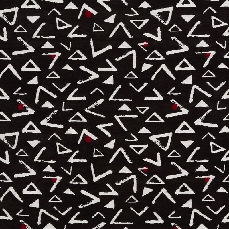 Black fabric patterned with irregular white triangles and chevron-like marks, and occasional small red teardrops; pattern repeats across the flat textile, creating a high-contrast abstract design.