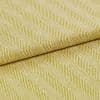 Yellow-green woven fabric with diagonal ribbed herringbone pattern; folded over itself, revealing layered texture; close-up studio-lit view emphasizing the weave and pattern across a flat surface.