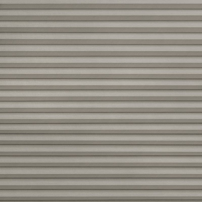 Horizontal pleated cellular blind, fully closed with evenly spaced fabric folds and subtle texture; blocking light and casting thin shadow lines; fills the frame in a neutral, softly lit interior.
