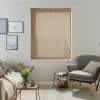 Beige horizontal slatted blinds, fully lowered with pull cords at right; closed, filtering soft daylight; neutral living room with sofa, armchair, side tables, framed art and vase.
love