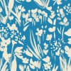 White abstract floral brushstrokes suggest flowers and leaves, scattered and clustered across a textured teal-blue background, forming a repeating, painterly textile or wallpaper pattern.
