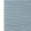 Light-blue cellular (honeycomb) shade, pleated horizontal cells with white interior along left edge; fully lowered and closed, blocking light; shown as product against a plain white background.