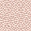 Dusty-pink and white diamond-patterned wallpaper, stepped-edge motifs repeating across the surface, covers the entire flat wall, evenly lit close-up with no visible furnishings or windows.