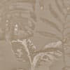 Large tropical leaves repeat across a beige woven fabric, printed in lighter and darker tan tones, creating a subtle botanical pattern with textured, distressed highlights.