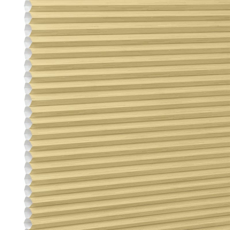 Honeycomb cellular blind, beige with visible hexagonal cells at left edge and narrow horizontal pleats — fully lowered and closed, filtering soft light in a close-up, neutral setting.