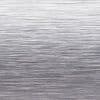 Brushed stainless-steel surface with fine horizontal grain; reflecting diffuse light and subtle highlights, close-up view suggesting a sheet-metal or appliance panel in a neutral, evenly lit studio context.