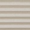 Pleated double-layered cellular shades, horizontal beige and ivory bands, lowered and closed, softly diffusing light; close-up view showing textured fabric panels across a neutral interior setting.