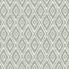 Woven textile or wallpaper with pale green and white stepped-diamond (ikat) pattern — repeating across the surface — used as decorative wallcovering or upholstery in a neutral, evenly lit interior.