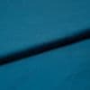 Teal satin fabric, folded diagonally with a soft sheen and subtle texture; fold casting a gentle shadow, close-up studio view with even lighting emphasizing the smooth surface.