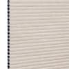 Beige cellular (honeycomb) window shade, pleated and fully lowered with exposed black cell openings along the left edge, blocking light and showing a textured fabric surface against a white background.