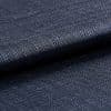 Dark navy woven fabric, tightly woven and folded over itself; its textured basket weave catches a subtle sheen, shown in a close-up macro view with soft, even lighting.