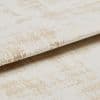 Crushed-velvet fabric with beige abstract pattern—folded and overlapped to reveal nap and edge; close-up, studio-lit view emphasizing soft texture and subtle sheen.