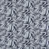 Wallpaper with pale-blue palm-leaf motifs — repeating pattern covering the surface — dark navy background, flat decorative wall or fabric showing layered tropical leaves under even lighting.