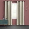 Grommet-top beige patterned curtains, hanging and slightly parted on a metal rod, framing a bright single-pane window; room with muted rose walls, teal midcentury sideboard, circular wall decor, soft daylight.