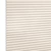 Cream honeycomb (cellular) window shade with horizontal pleats and visible hexagonal cells, fully lowered and closed, softly diffusing light; photographed as a studio product shot with neutral background.