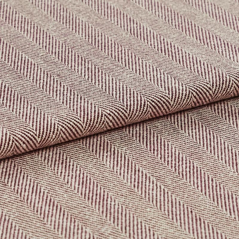 Woven upholstery fabric with beige-and-burgundy diagonal herringbone stripes and ribbed texture; folded and overlapped to reveal the pattern repeat; close-up, evenly lit studio setting.