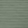 Pale-green horizontal metal rolling shutter with narrow ribbed slats dominates frame; fully closed, slightly weathered; exterior storefront or garage façade under even daylight.