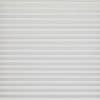 White horizontal pleated blinds covering the entire window, narrow evenly spaced slats; closed and softly diffusing daylight; set against a neutral wall in a bright, minimal interior.