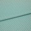 Folded teal-and-white chevron fabric (zigzag pattern) — folded once forming a horizontal seam — close-up, evenly lit textile filling the frame, showing texture and repeating geometric pattern.