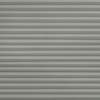Gray horizontal pleated blinds, fully closed with overlapping slats, blocking light; occupying a window in a softly lit room, creating a uniform, layered shadow pattern.