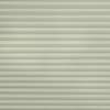 Pleated cellular window shade, fully lowered with uniform horizontal pleats and subtle herringbone fabric texture; closed to block view and softly diffuse daylight across a pale, neutral interior surface.