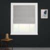 Light-gray Roman shade with soft horizontal folds, lowered and filtering daylight. White-trimmed window set in dark charcoal wall; small wooden side table with glass dome and framed abstract print nearby.
