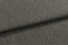 Gray textured upholstery fabric, folded over itself forming a horizontal overlap; revealing tight weave and slight nap; close-up view under soft, even lighting.