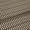 Brown-and-cream patterned textile (rectangular geometric motif) folded over itself; tufted loops create raised texture, shown in tight close-up under even studio lighting on a neutral background.