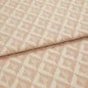 Woven pink geometric jacquard fabric, folded over itself, displaying raised cream triangular diamond pattern; close-up on a flat surface with soft, even studio lighting emphasizing texture.